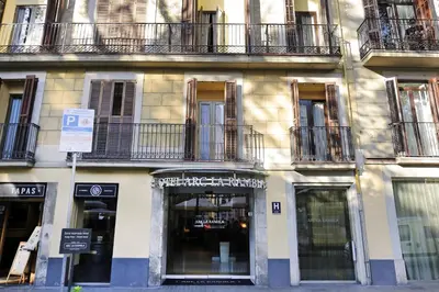 a building with windows and balconies on a street at Arc La Rambla in Barcelona