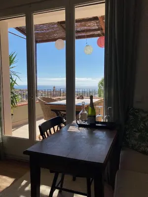 a dining room table with a view of the ocean at Cozy place, big roof terrace & spectacular views. in Cabrils
