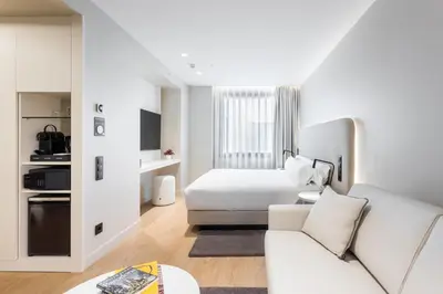 a white room with a bed and a couch at Royal Ramblas in Barcelona