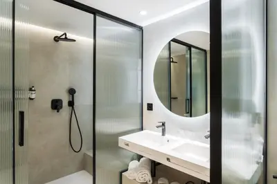 a bathroom with a shower and a sink and a mirror at Royal Ramblas in Barcelona