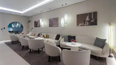a waiting room with couches and tables and chairs at Royal Ramblas in Barcelona