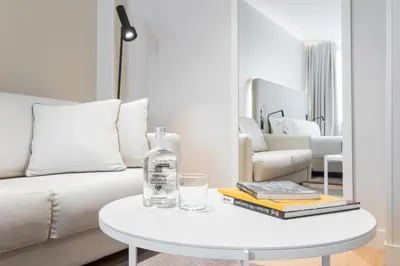 a white living room with a white couch and a table at Royal Ramblas in Barcelona