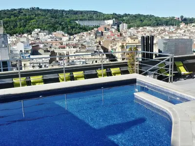 a hotel room with a bed and a television at Hotel Barcelona Universal in Barcelona