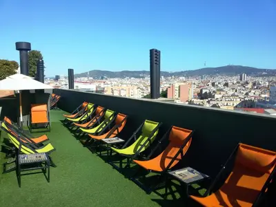 a row of chairs sitting on top of a roof at Hotel Barcelona Universal in Barcelona