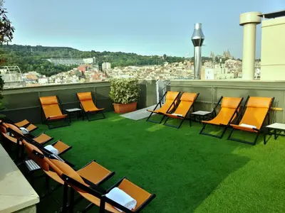 a group of chairs and tables on a roof at Hotel Barcelona Universal in Barcelona