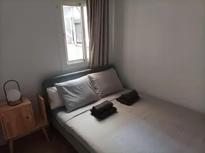 a bed in a room with two pillows on it at COOL! 5' to metro. 15' to Center/beach by metro. in Santa Coloma de Gramanet