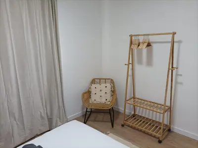 a bedroom with a bed and a chair and a mirror at COOL! 5' to metro. 15' to Center/beach by metro. in Santa Coloma de Gramanet