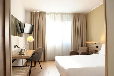 a hotel room with a bed and a desk at Eurohotel Diagonal Port in Barcelona
