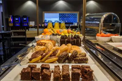a sandwich and chips and a drink on a table at Eurohotel Diagonal Port in Barcelona