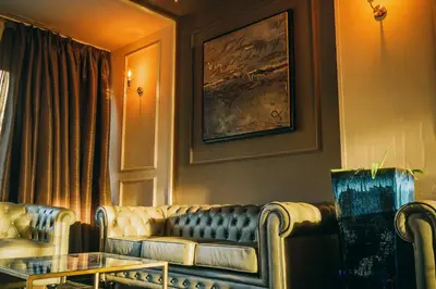 a living room with a couch and a table at Eurohotel Diagonal Port in Barcelona