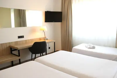 two beds sitting next to each other in a room at Eurohotel Diagonal Port in Barcelona