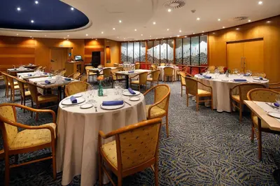 a dining room with tables and chairs in a restaurant at HCC Montblanc in Barcelona