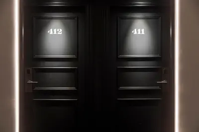 two black doors with the numbers on them at H10 Itaca in Barcelona