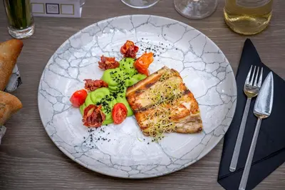 a plate of food with fish and vegetables on a table at Hotel SERHS Rivoli Rambla in Barcelona