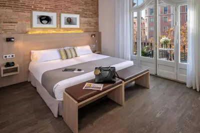 a hotel room with a large bed and a window at Hotel SERHS Rivoli Rambla in Barcelona