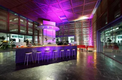 a kitchen with purple lighting and a bar with stools at Eurostars Grand Marina Hotel GL in Barcelona