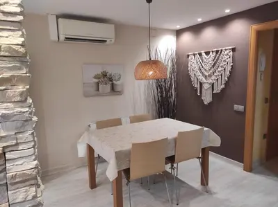 a dining room with a white table and chairs at Apartamento en Viladecans cerca del aeropuerto in Viladecáns
