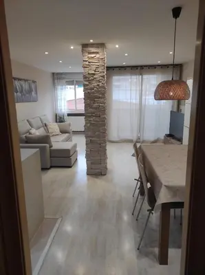 a living room with a table and a living room with a couch at Apartamento en Viladecans cerca del aeropuerto in Viladecáns