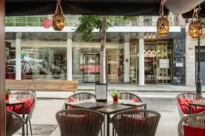 a table and chairs in front of a restaurant at NH Collection Barcelona Gran Hotel Calderon in Barcelona