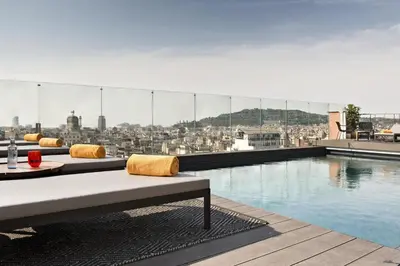 a rooftop pool with a view of a city at NH Collection Barcelona Gran Hotel Calderon in Barcelona