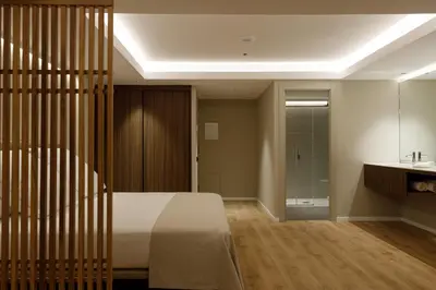 a hotel room with a bed and a table and chairs at Aparthotel Mariano Cubi Barcelona in Barcelona