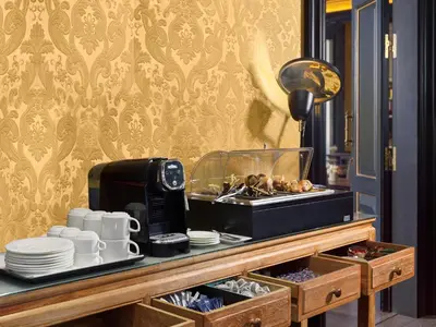 a buffet with plates and cups and a coffee maker at Boutique Hotel H10 Catalunya Plaza in Barcelona