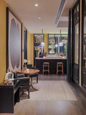 a lobby with a table and chairs and a salon at Boutique Hotel H10 Catalunya Plaza in Barcelona