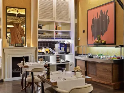 a restaurant with tables and chairs and a fireplace at Boutique Hotel H10 Catalunya Plaza in Barcelona