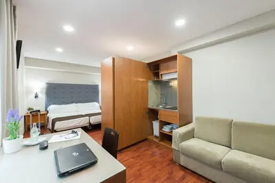 a room with a desk and a bed and a couch at Senator Barcelona Apartments in Barcelona