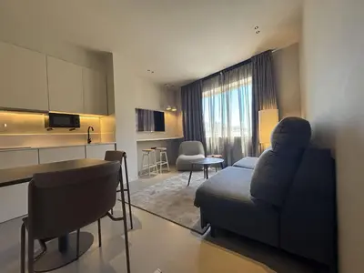 a hotel room with a bed and a dining room at Senator Barcelona Apartments in Barcelona