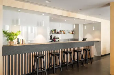 a bar in a restaurant with stools at Ronda House in Barcelona