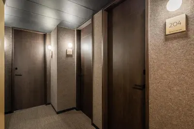 a hallway with two doors and a sign on the wall at Ronda House in Barcelona