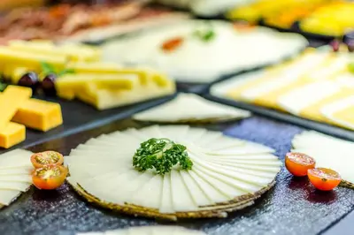a table topped with cheese and other food items at Exe Barbera Parc in Barbera del Valles