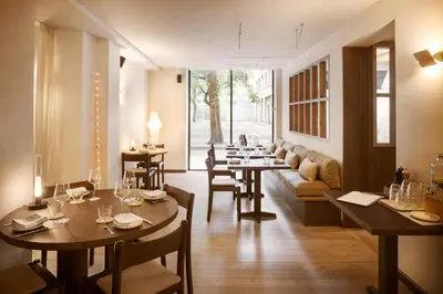 a restaurant with tables and chairs and a couch at Hotel Casa Teva Barcelona in Barcelona