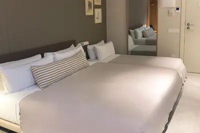 a large white bed with pillows in a room at Hotel Casa Teva Barcelona in Barcelona