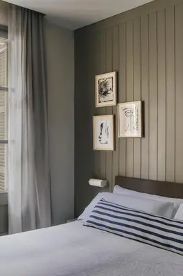 a bedroom with a bed and three pictures on the wall at Hotel Casa Teva Barcelona in Barcelona
