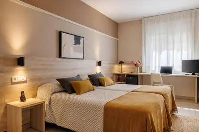a bedroom with a large bed and a television at Bonanova Park in Barcelona