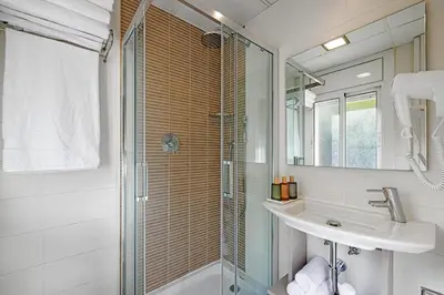 a bathroom with a glass shower and a sink at Bonanova Park in Barcelona