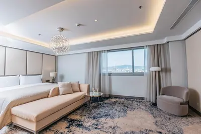 a bedroom with a bed and a couch and a chair at InterContinental Barcelona by IHG in Barcelona