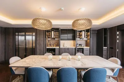a dining room with a table and blue chairs at InterContinental Barcelona by IHG in Barcelona