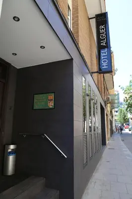 a building with a sign on the side of it at Hotel Alguer Camp Nou in Barcelona