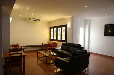 a living room with a couch and a table at Hotel Alguer Camp Nou in Barcelona