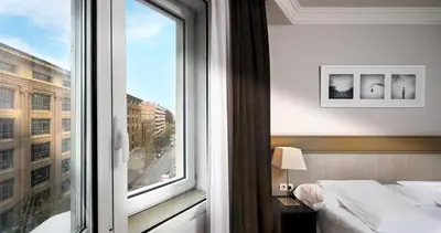 a bedroom with a window with a bed and a view at Hotel Condado in Barcelona