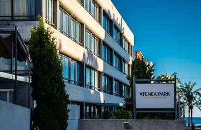 a building with a sign in front of it at Atenea Park Suites & Apartments in Vilanova i la Geltrú