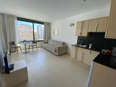 a living room with a couch and a table at Atenea Park Suites & Apartments in Vilanova i la Geltrú