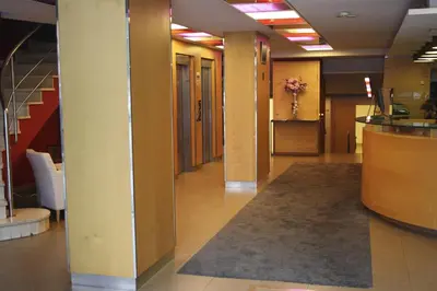 a hallway of an office with a lobby with stairs at Hotel Abbot in Barcelona