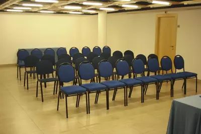 a row of blue chairs in a room at Hotel Abbot in Barcelona