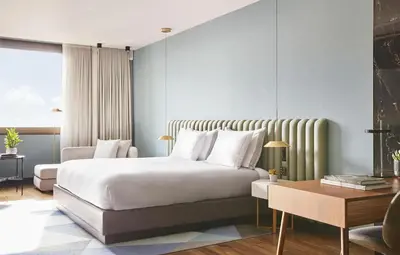 a bedroom with a large bed and a table at Grand Hyatt Barcelona in Barcelona