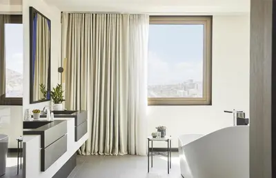 a bathroom with a tub and a large window at Grand Hyatt Barcelona in Barcelona