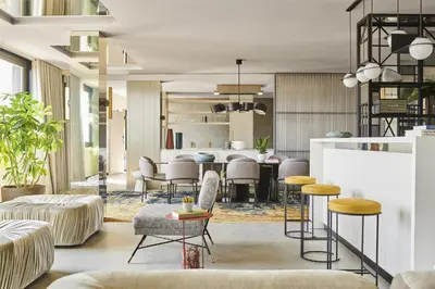 a living room with stools and a table at Grand Hyatt Barcelona in Barcelona